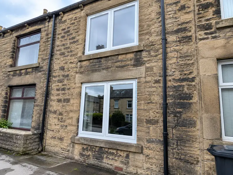 New white uPVC windows fitted on a stone terraced house in Halifax